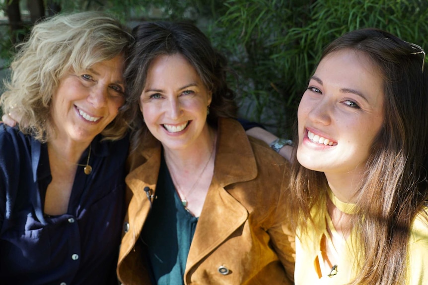 Margie, Anna and Emily smile outside the studio