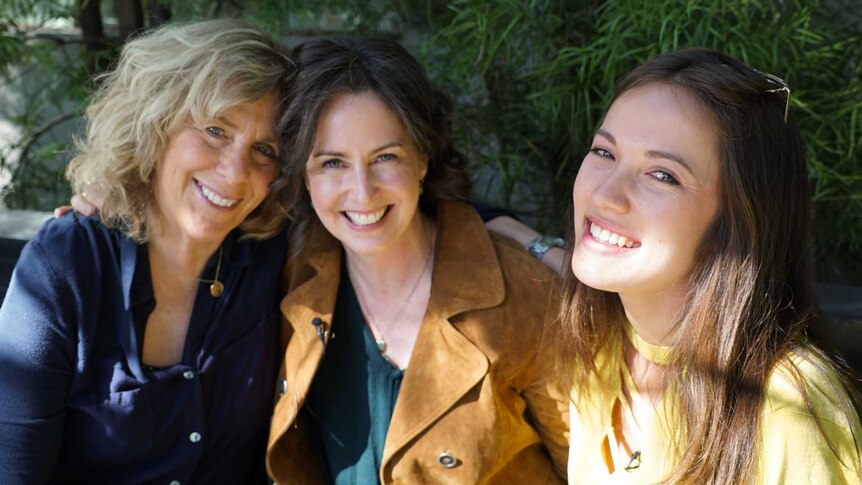 Margie, Anna and Emily smile outside the studio