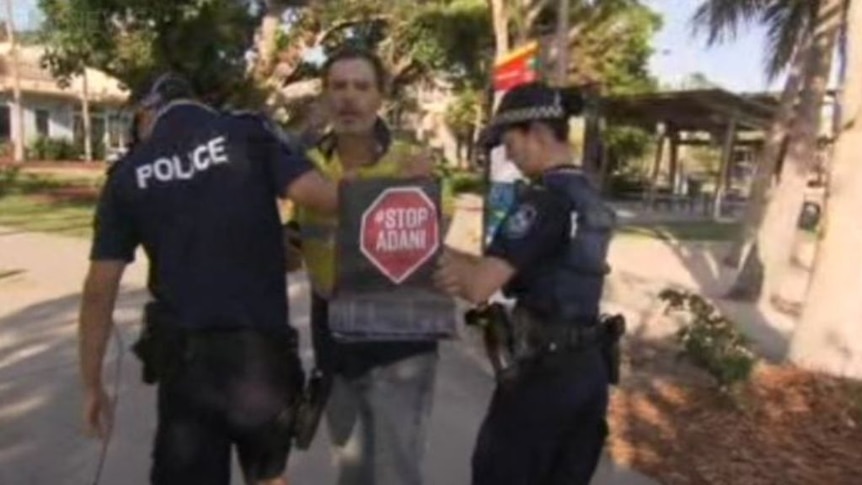 Protesters being taken away by security after confronting Queensland Premier in Airlie Beach