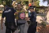 Protesters being taken away by security after confronting Queensland Premier in Airlie Beach