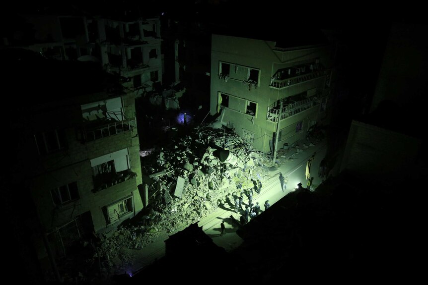 Rescue workers search for victims in Douma, Syria