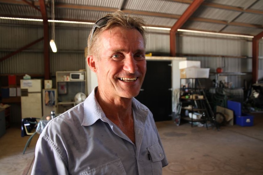 A photo of Don Bacon in his shed where the piano is currently stored.