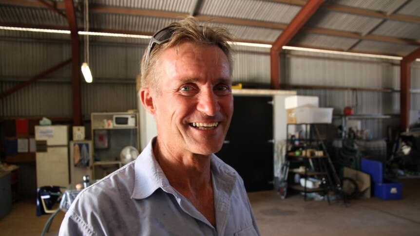 A photo of Don Bacon in his shed where the piano is currently stored.