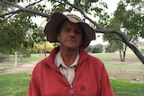 Farmer Pat Murphy poses in front of a tree