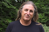 Portrait of a man with long hair outdoors 