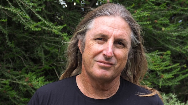 Portrait of a man with long hair outdoors