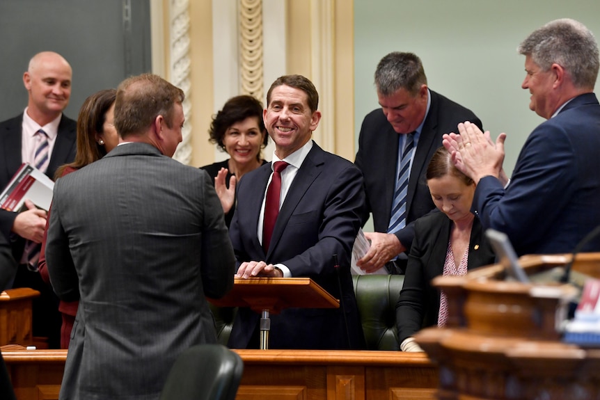 Cameron Dick is applauded by colleagues.