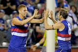 Liam Jones and Stewart Crameri celebrate a goal for the Western Bulldogs against Richmond.