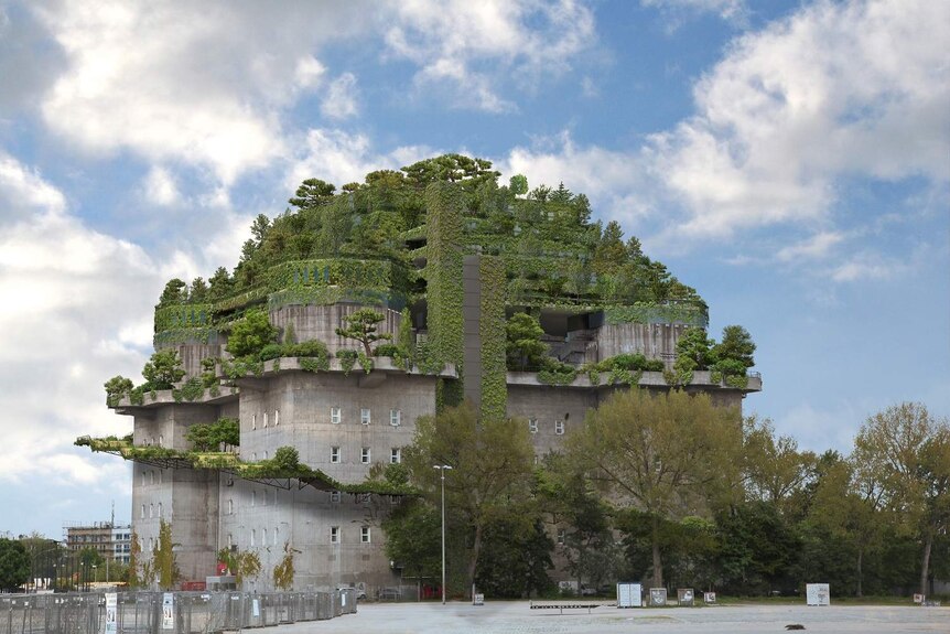 A grey concrete building is covered in a green garden.