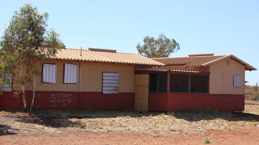 A house with its windows boarded up in Parnpajinya Community.