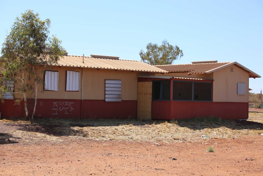 A house with its windows boarded up in Parnpajinya Community.