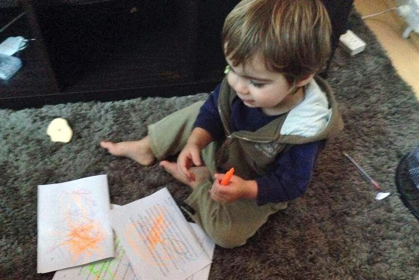 A young boy writes on a types manuscript using a highlighter pen.
