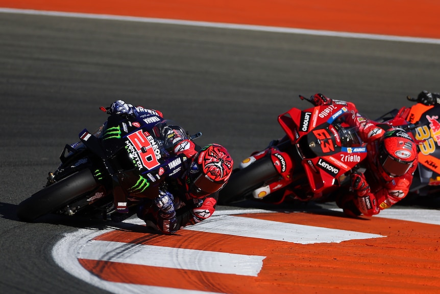 Fabio Quartararo and Francesco Bagnaia ride around a corner