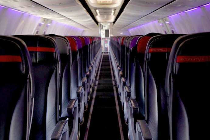 Rows of empty seats on a grounded Inside Virgin Australia aircraft.