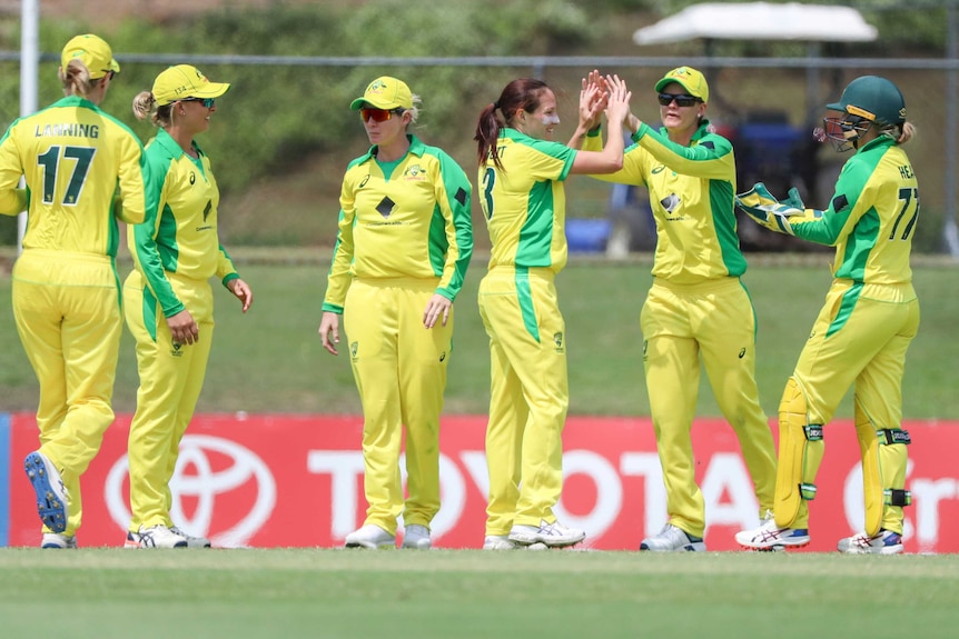 Australian women cricket players congratulate each other following a Sri Lanka wicket.