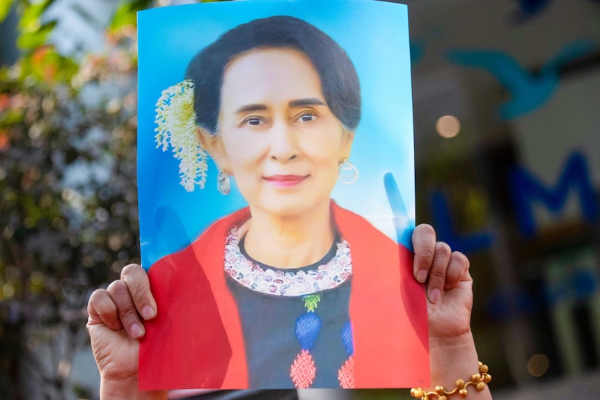 A photo of Aung San Suu Kyi is held up