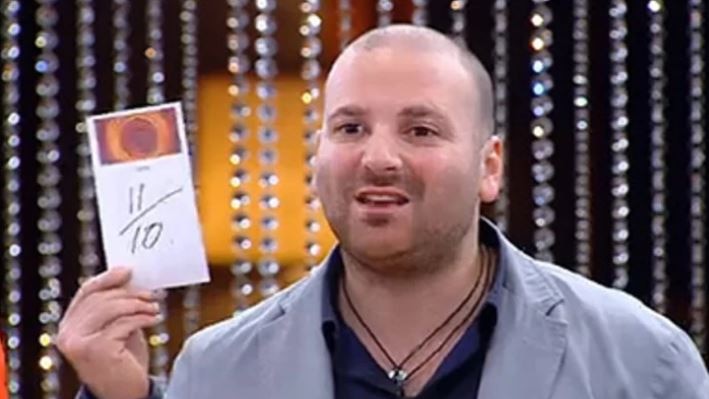 George Calombaris holds up a sign giving a score of 11 out of 10.