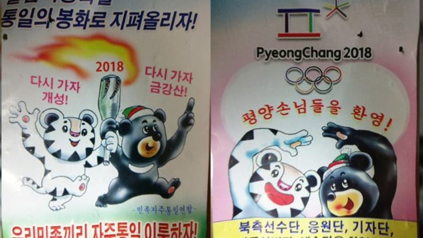 North Korea propaganda posters show Winter Olympics mascots carrying an olympic torch and slogans written in North Korean.