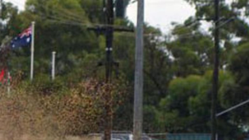 A car drives through deep water causing spray on Lionel St Kalgoorlie