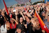 hundreds of supporters of Turkey's President chant and hold flags