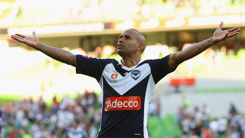 Archie Thompson with arms outstretched thanking the Victory supporters