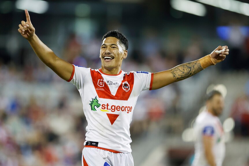 A rugby league player celebrates a victory 