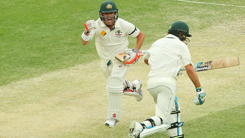 Australia's David Warner celebrates his century on day three of the first Test at the Gabba.