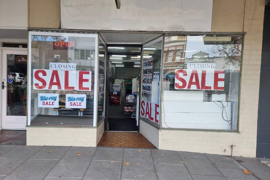 Two large sale signs on a shopfront