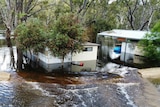 Caravans sit in floodwater. 
