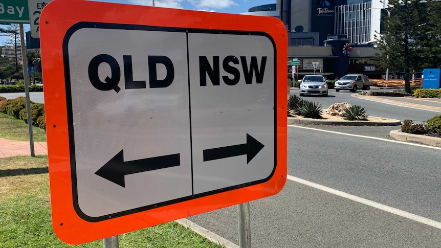 A road sign that reads "Qld" and "NSW".