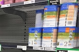 Empty shelves in the baby formula aisle of a supermarket.
