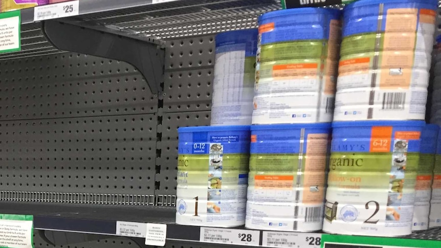 Empty shelves in the baby formula aisle of a supermarket.