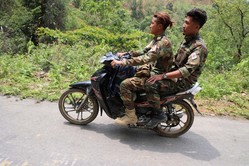 Two men on a motorbie.