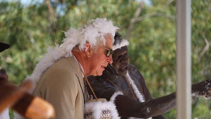 Prince Charles with traditional owners in Nhulunbuy wearing traditional dress.