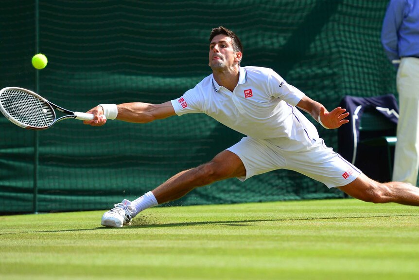 Novak Djokovic stretches for the ball at Wimbledon