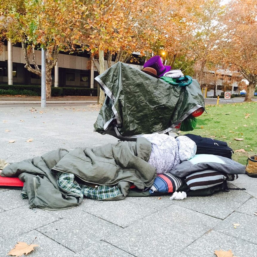 A homeless man sleeps on the street in Perth