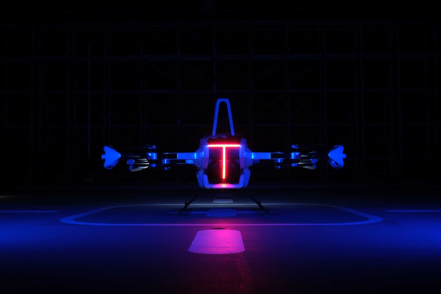 An image of a grounded flying car lit up by sensor lights