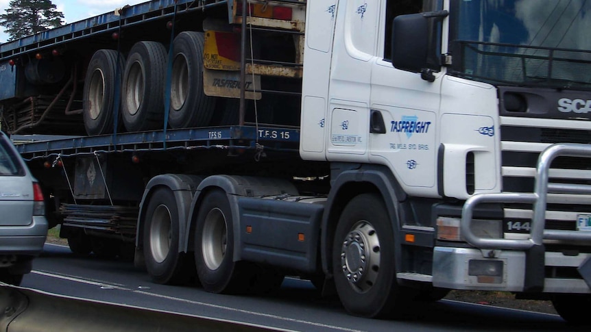 A truck passes a car on a Tasmanian road.