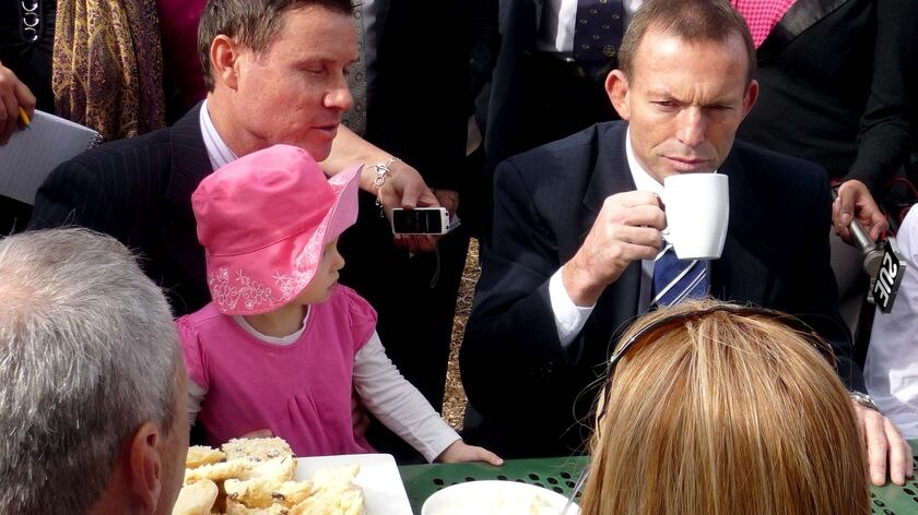 Opposition Leader Tony Abbott has a cup of tea while campaigning
