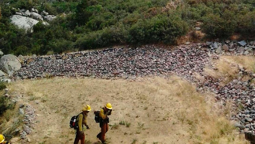 Arizona firefighters move away from a wildfire near the town of Yarnell