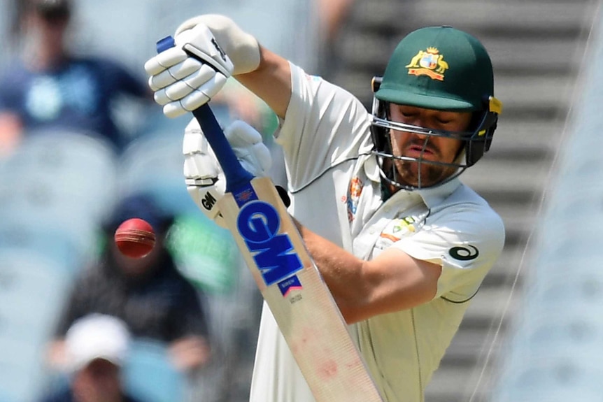 Travis Head hends the ball away while batting at the MCG.