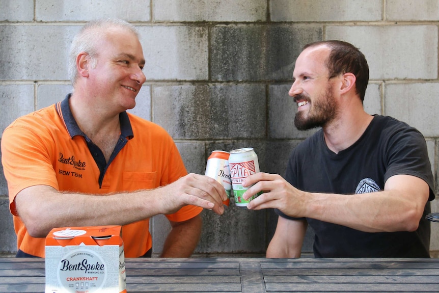 Richard Watkins and Adrian Graeber share a beer.