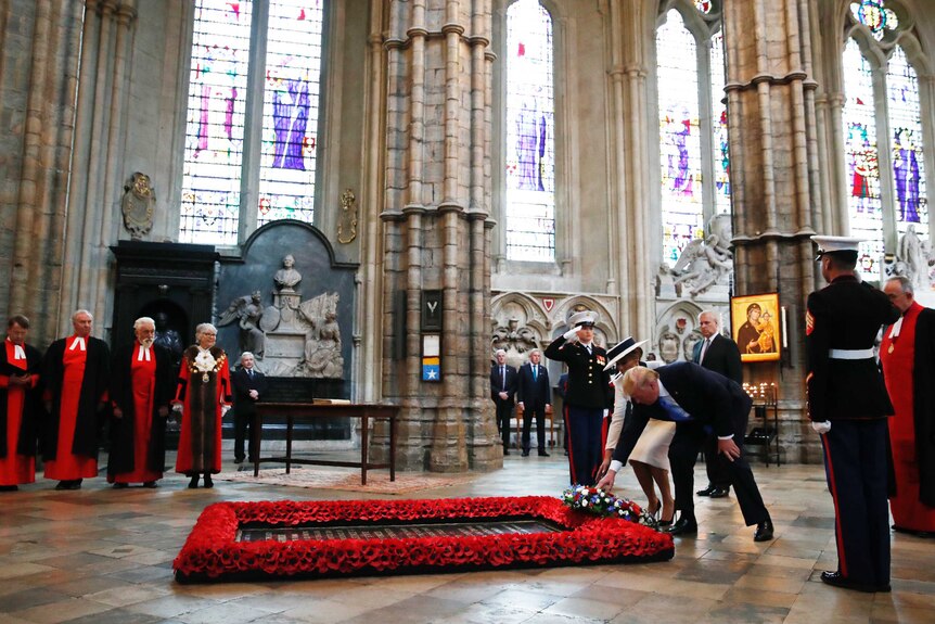 President Donald Trump and first lady Melania Trump place a wreath at the grave of the Unknown Warrior at Westminster Abbey