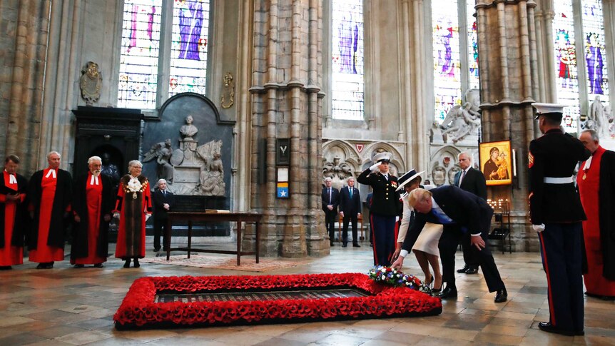 President Donald Trump and first lady Melania Trump place a wreath at the grave of the Unknown Warrior at Westminster Abbey
