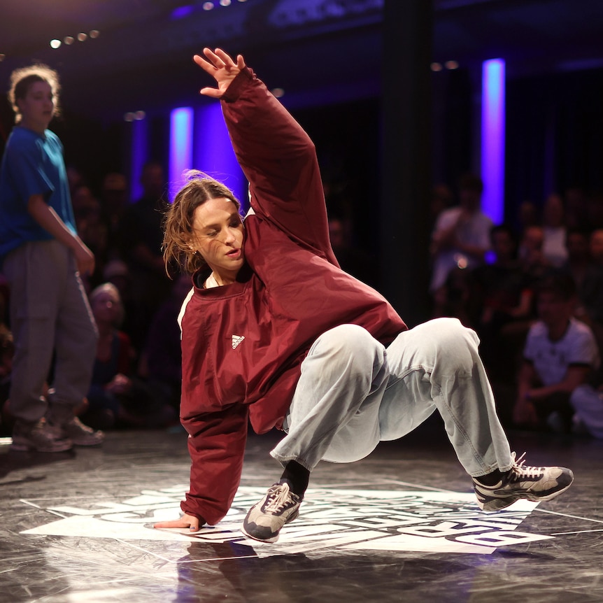 A woman performs during a breakdancing competition