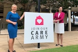 Kate Jones and Annastacia Palaszczuk stand on either side of a sign that says "join our care army'
