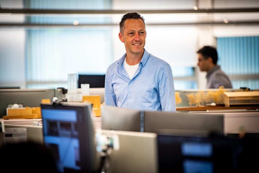 A man in an open-plan office environment