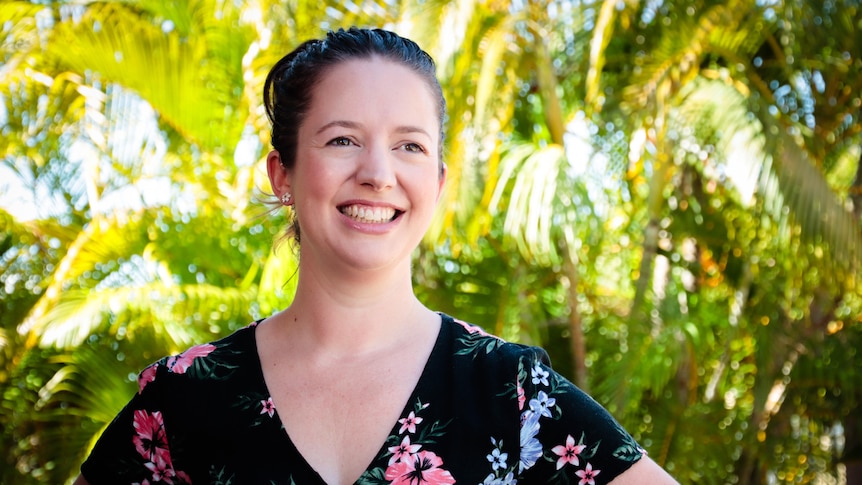 a woman smiling in a garden