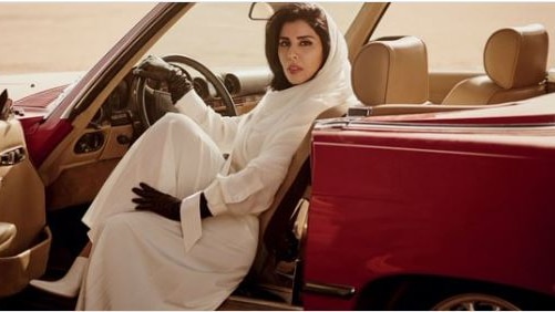 Princess Haifa is seen in the driver's seat of a red convertible.