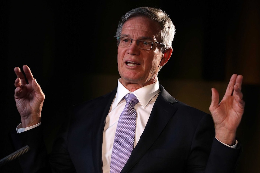 A headshot of Mike Nahan against a black background.